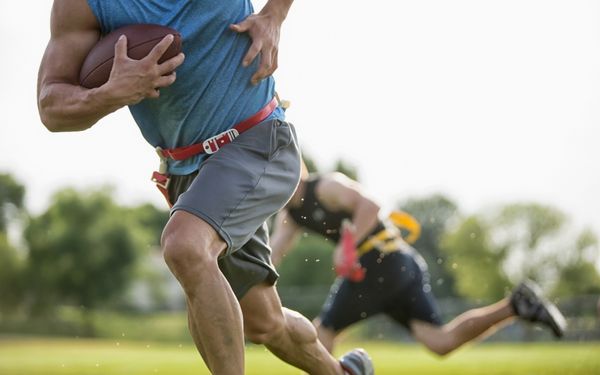 adults playing flag football